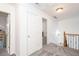 Hallway featuring white doors, neutral walls, gray carpet, and decorative railing at 820 Nob Ridge Dr, Marietta, GA 30064