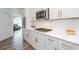 Kitchen with white cabinets, stainless steel appliances, quartz countertops and hardwood floors at 820 Nob Ridge Dr, Marietta, GA 30064