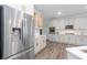 Modern kitchen showcasing stainless steel refrigerator, white cabinets with gold hardware, and hardwood flooring at 820 Nob Ridge Dr, Marietta, GA 30064