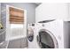 Bright laundry room with modern washer and dryer and natural light from the window at 820 Nob Ridge Dr, Marietta, GA 30064