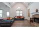 Comfortable living room featuring high ceilings, stone fireplace, and wood-look flooring at 820 Nob Ridge Dr, Marietta, GA 30064