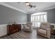 Living room featuring wood floors, shutters, ceiling fan, and two comfortable armchairs at 820 Nob Ridge Dr, Marietta, GA 30064