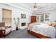 Serene main bedroom featuring plush carpet, decorative fireplace, and large windows with a view of the pool at 820 Nob Ridge Dr, Marietta, GA 30064