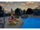 Backyard patio with umbrella and chairs near the pool at dusk at 820 Nob Ridge Dr, Marietta, GA 30064
