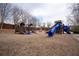 Community playground area featuring two wooden play structures with blue slides and a wood chip ground covering at 820 Nob Ridge Dr, Marietta, GA 30064