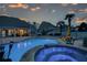 Beautiful backyard pool and hot tub with stone trim, patio and palm trees at dusk at 820 Nob Ridge Dr, Marietta, GA 30064