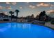 Beautiful backyard pool with stone trim, waterfall feature, patio and landscape lighting at 820 Nob Ridge Dr, Marietta, GA 30064