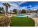 Inviting backyard pool area with a lush green lawn, lounge chairs, and a yellow umbrella at 820 Nob Ridge Dr, Marietta, GA 30064