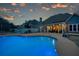 Beautiful backyard pool at dusk with accent lighting, and a covered patio at 820 Nob Ridge Dr, Marietta, GA 30064