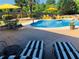 Sparkling swimming pool with yellow umbrellas, sun loungers, and a well-maintained patio area, perfect for relaxation at 820 Nob Ridge Dr, Marietta, GA 30064