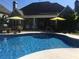 Gorgeous pool with a jacuzzi featuring an umbrella and patio, perfect for relaxing and enjoying the outdoors at 820 Nob Ridge Dr, Marietta, GA 30064