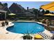 Beautiful swimming pool with lounge chairs, umbrellas, and lush greenery for a tranquil outdoor living experience at 820 Nob Ridge Dr, Marietta, GA 30064
