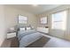 Stylish bedroom with a comfortable bed, contemporary decor, and lots of natural light at 146 Silverton Dr, Dacula, GA 30019