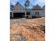 New construction home with open garage door and landscaping materials on the front lawn at 146 Silverton Dr, Dacula, GA 30019