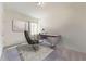 Bright home office with a large desk, modern chair, and a window for natural light at 146 Silverton Dr, Dacula, GA 30019