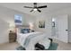 Bright bedroom with a ceiling fan, white walls, and modern decor with an attached bathroom at 1576 Elixir Sw Ave, Atlanta, GA 30314