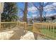 Image of a new wood deck with railing, steps to the yard and a view of mature trees at 1576 Elixir Sw Ave, Atlanta, GA 30314
