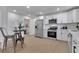 Modern kitchen featuring white cabinets, stainless steel appliances, and an adjacent dining area at 1576 Elixir Sw Ave, Atlanta, GA 30314