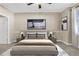 Inviting bedroom with large windows, two side tables and lamps, a light blue rug, and neutral walls at 2400 Cumberland Se Pkwy # 212, Atlanta, GA 30339