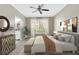 Bedroom features a large window with bright natural light, ceiling fan, and decorative accent pieces at 2400 Cumberland Se Pkwy # 212, Atlanta, GA 30339