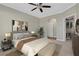 Cozy bedroom with a large bed, closet, ceiling fan, and carpeted floors at 2400 Cumberland Se Pkwy # 212, Atlanta, GA 30339