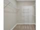 Walk-in closet features installed shelving and a carpeted floor at 2400 Cumberland Se Pkwy # 212, Atlanta, GA 30339