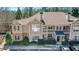 Beautiful condo showcasing stone accents, balcony, mature trees, and ample parking space at 2400 Cumberland Se Pkwy # 212, Atlanta, GA 30339