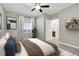 This bedroom features a window with blinds, decorative shelving, and adjoins the ensuite bathroom at 2400 Cumberland Se Pkwy # 212, Atlanta, GA 30339