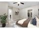 This bedroom features a ceiling fan, decorative shelving, and an ensuite bathroom with walk-in closet at 2400 Cumberland Se Pkwy # 212, Atlanta, GA 30339