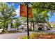 Landscaped entrance to Vinings Jubilee with lush trees and well-maintained signage at 2400 Cumberland Se Pkwy # 212, Atlanta, GA 30339