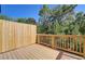 Wooden deck with a railing and a view of lush greenery and tall trees at 7016 Fringe Flower Dr # 88, Austell, GA 30168