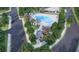 Aerial view of community pool with lounge chairs and pergola surrounded by beautiful greenery at 118 Stonehouse Drive Way, Cumming, GA 30040
