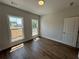 Bedroom with hardwood floors, neutral paint, double windows, and a white door at 118 Stonehouse Drive Way, Cumming, GA 30040