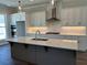 Bright kitchen features a large island with a sink, stainless appliances, and modern lighting at 118 Stonehouse Drive Way, Cumming, GA 30040