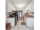 Efficient kitchen with white cabinets, black appliances, and tile flooring at 134 Springstead Ct, Marietta, GA 30060