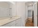 Bathroom with a white cabinet and a light cream countertop, a single sink, and a large mirror at 801 Dobby Way (Lot 92), Mcdonough, GA 30252