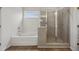 Bathroom with a bathtub with a tile backsplash and a glass door shower at 801 Dobby Way (Lot 92), Mcdonough, GA 30252