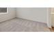 A large bedroom with neutral carpeting with white walls at 801 Dobby Way (Lot 92), Mcdonough, GA 30252
