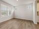 Neutral room showcasing new hardwood floors, two windows with blinds, and modern interior design elements at 801 Dobby Way (Lot 92), Mcdonough, GA 30252