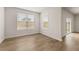 Well-lit room with hardwood floors and large windows offering views of the outdoors, creating a serene atmosphere at 801 Dobby Way (Lot 92), Mcdonough, GA 30252