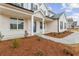 Inviting front porch with painted brick, columns, tasteful landscaping, and a charming entrance into this lovely home at 801 Dobby Way (Lot 92), Mcdonough, GA 30252
