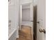 Hallway with light cream-colored walls, light wood-like flooring, and white doors at 801 Dobby Way (Lot 92), Mcdonough, GA 30252