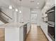 Bright, modern kitchen with stainless steel appliances, a large island, and ample counter space at 801 Dobby Way (Lot 92), Mcdonough, GA 30252