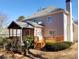 A spacious deck and covered porch offer outdoor living space in this home's well-kept backyard with mature landscaping at 2860 Pine St, Duluth, GA 30096