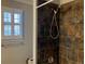 Bathroom featuring a tiled shower and window at 2860 Pine St, Duluth, GA 30096