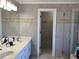 Bathroom featuring double sinks, granite countertops, stylish tile and a seamless glass shower at 2860 Pine St, Duluth, GA 30096