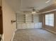 Spacious bonus room featuring a ceiling fan, neutral carpet, and a full wall of built-in shelving at 2860 Pine St, Duluth, GA 30096