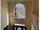 Grand foyer with a chandelier and a large arched window offering exterior views, enhancing natural light at 2860 Pine St, Duluth, GA 30096
