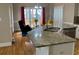 Bright eat-in kitchen island with granite countertops, stainless steel appliances, and a cozy breakfast nook at 2860 Pine St, Duluth, GA 30096