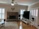 Cozy living room featuring a stone fireplace and hardwood floors at 2860 Pine St, Duluth, GA 30096